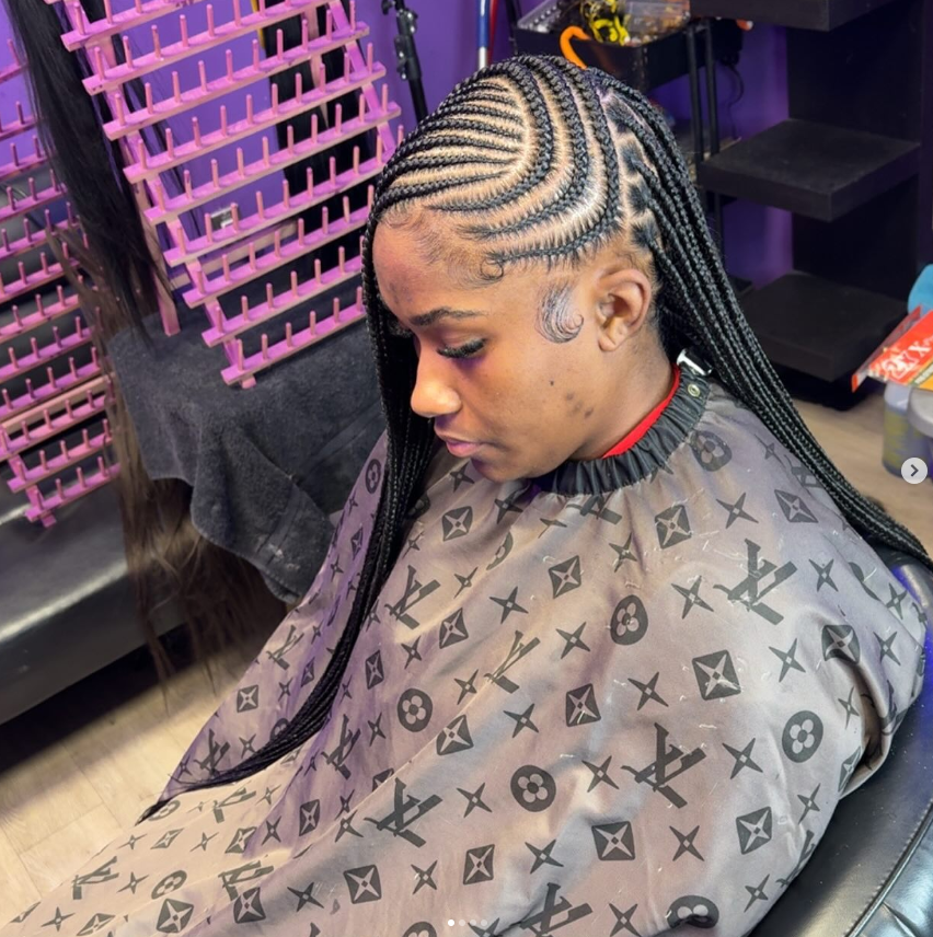 Stylish side braid hairstyle with neat cornrows and long knotless braids.