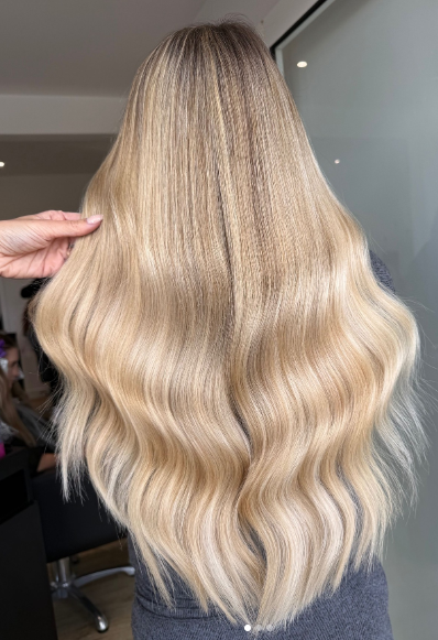Rooted creamy spring blonde hair is perfect for a natural and low-maintenance blonde look.