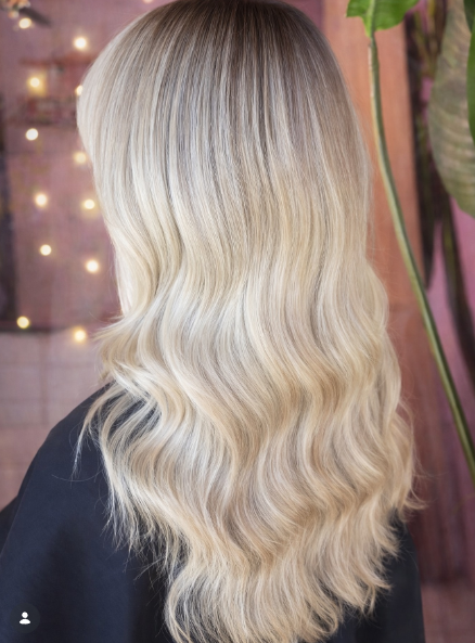Soft cream blonde balayage with a shadow root is a beautiful blonde hairstyle that blends darker roots into creamy blonde lengths.