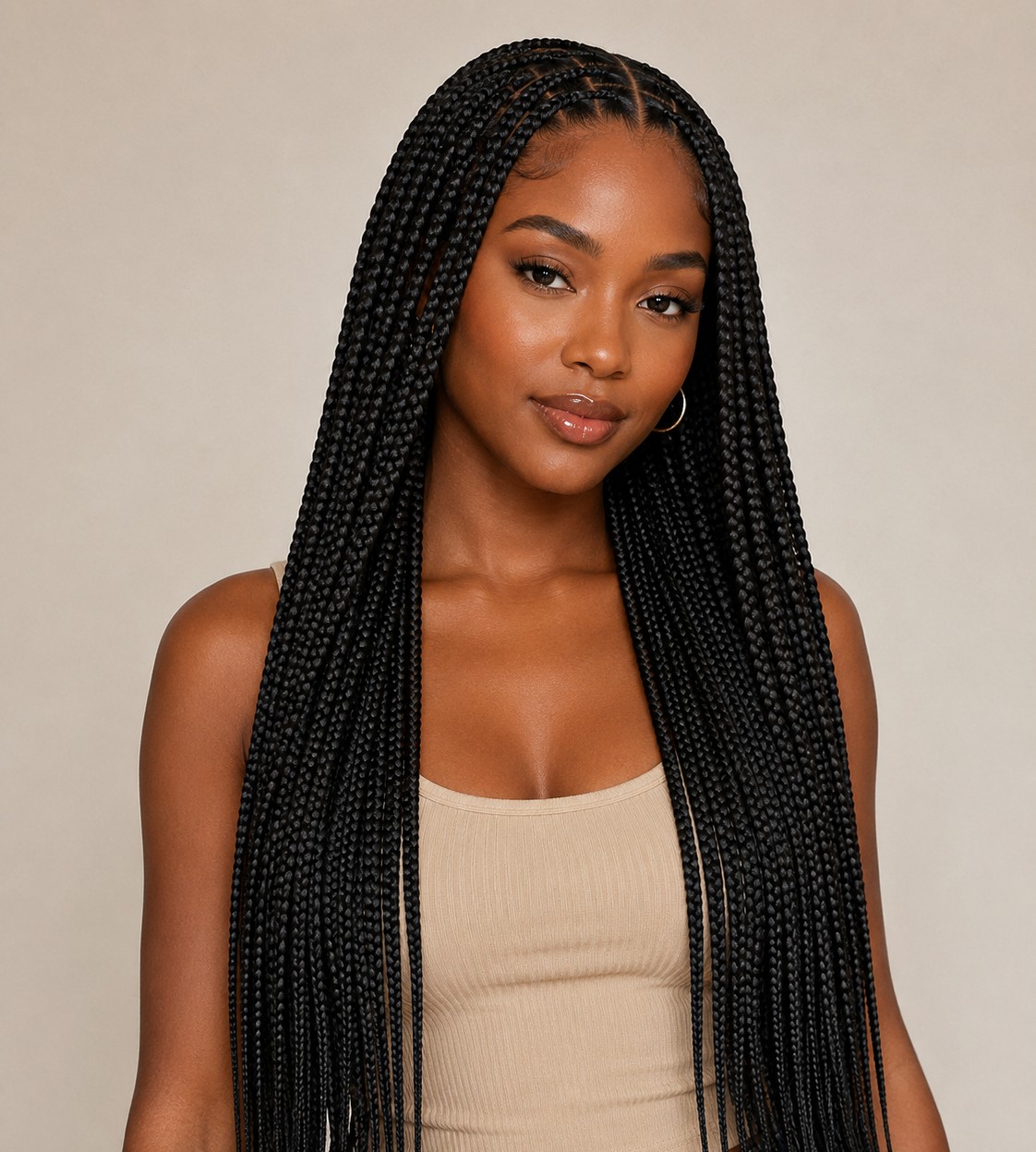 Classic knotless box braids are the foundation style, featuring medium-sized square sections braided smoothly from the root without a bulky knot.