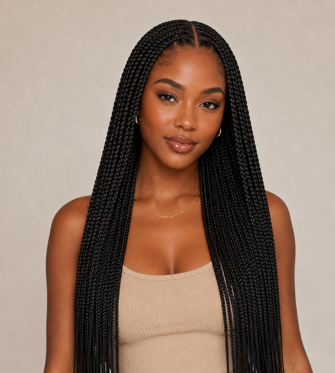 A clean middle part gives knotless braids a symmetrical, classic look that's easy to maintain day to day.