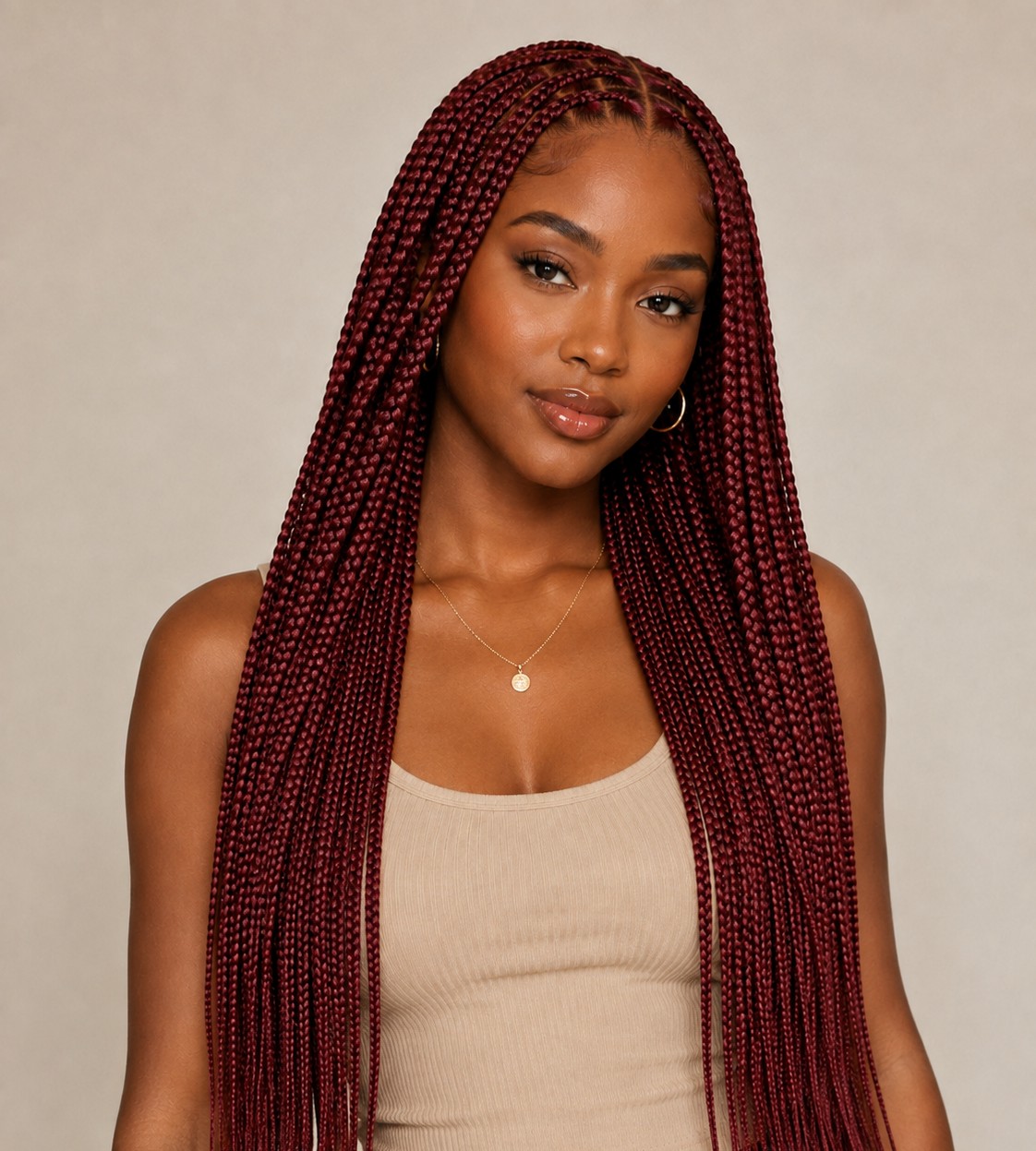 Bold colored extensions transform knotless braids into a vibrant style statement, from deep burgundy to fiery copper tones.