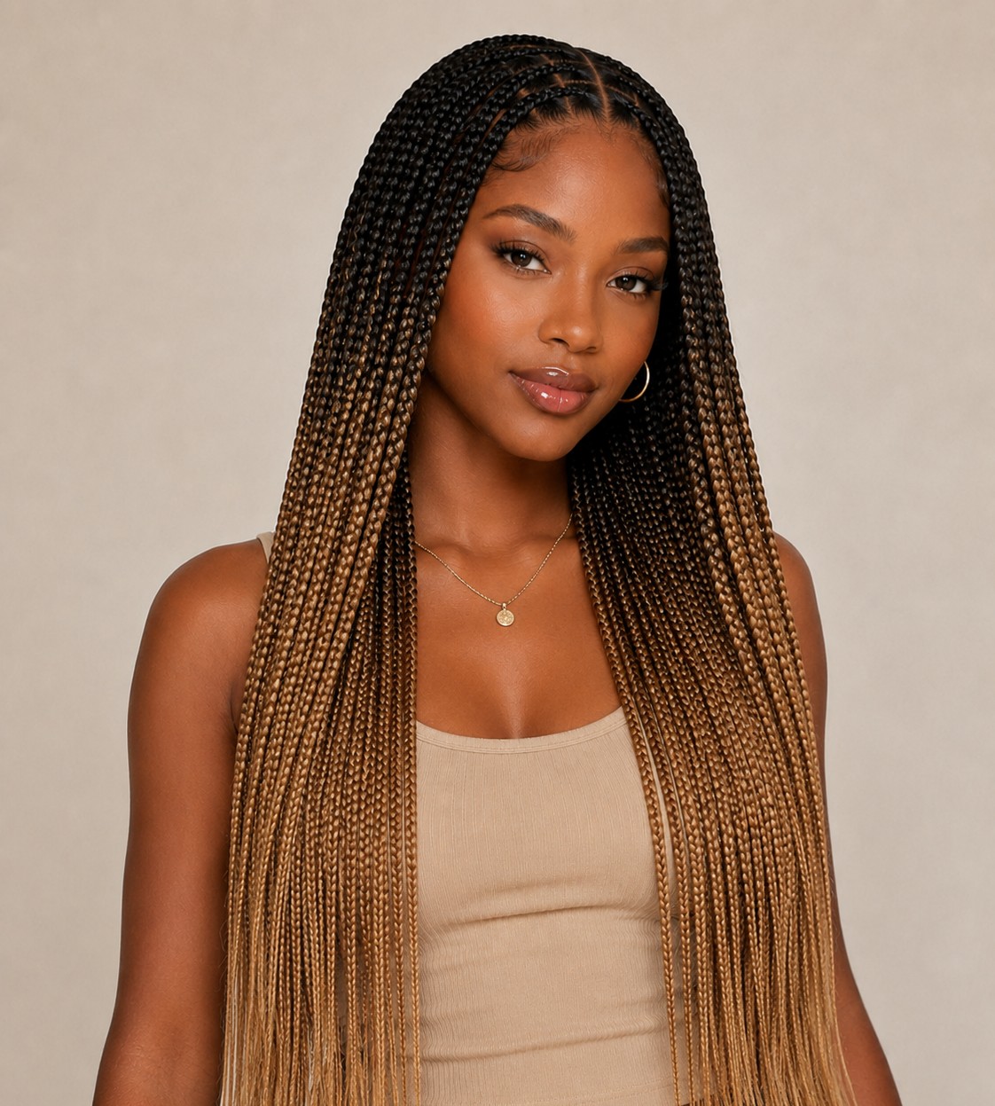 Ombre knotless braids transition smoothly from a darker root color to a lighter shade at the ends.