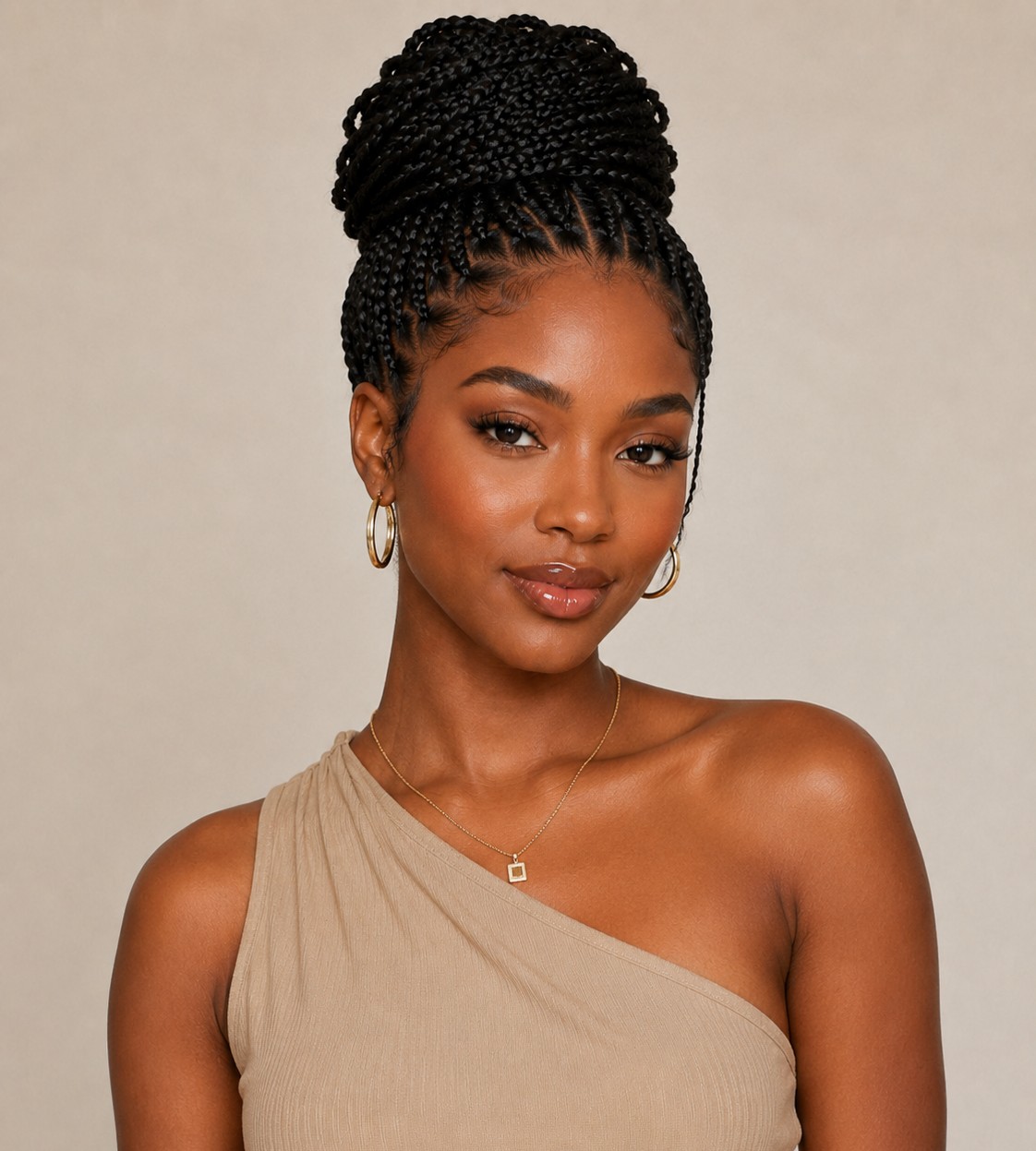An updo gathers all knotless braids into a twisted, pinned style at the crown for a polished, formal look.