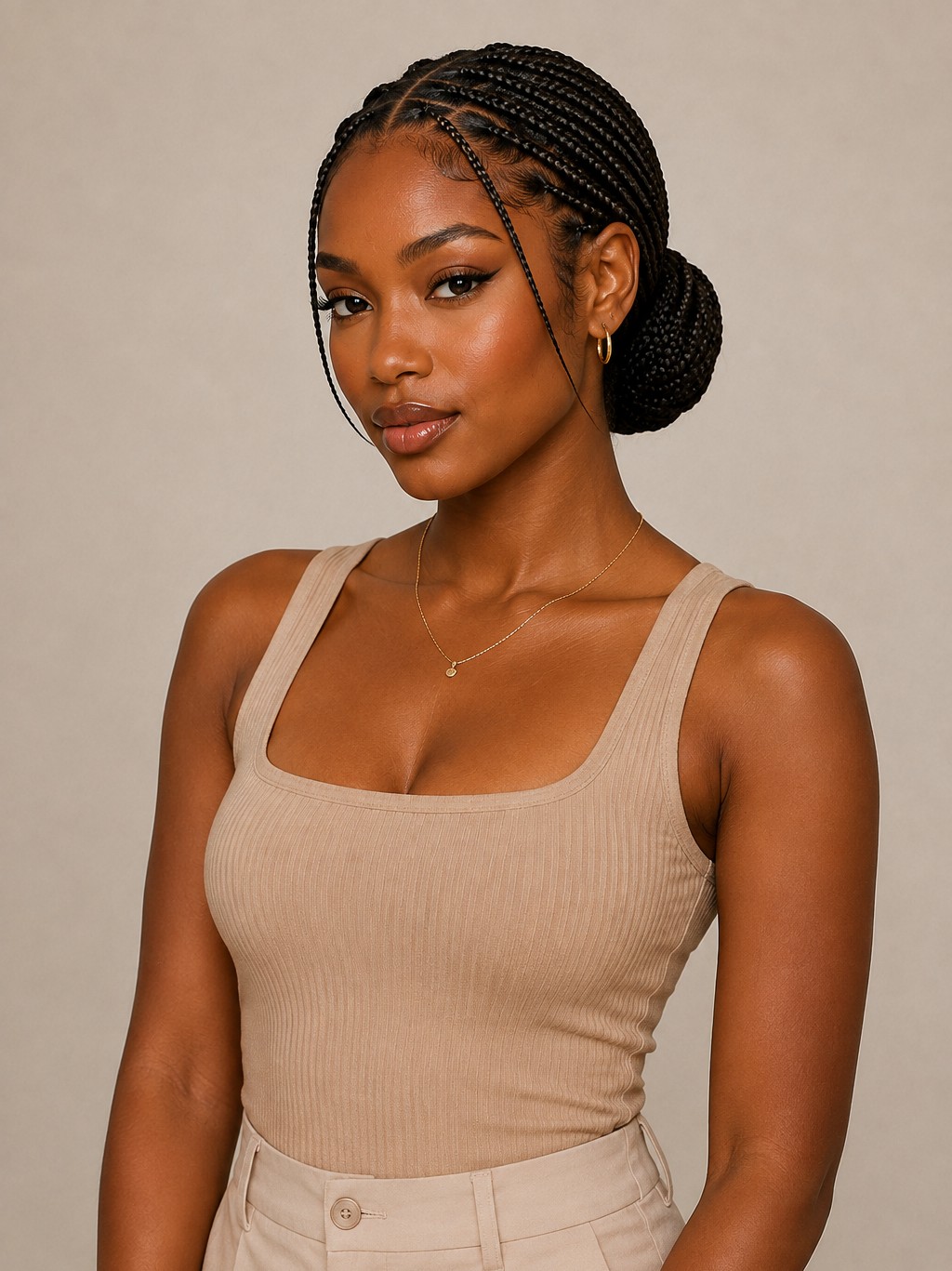 A low bun gathers all braids into a neat, coiled style at the nape of the neck.