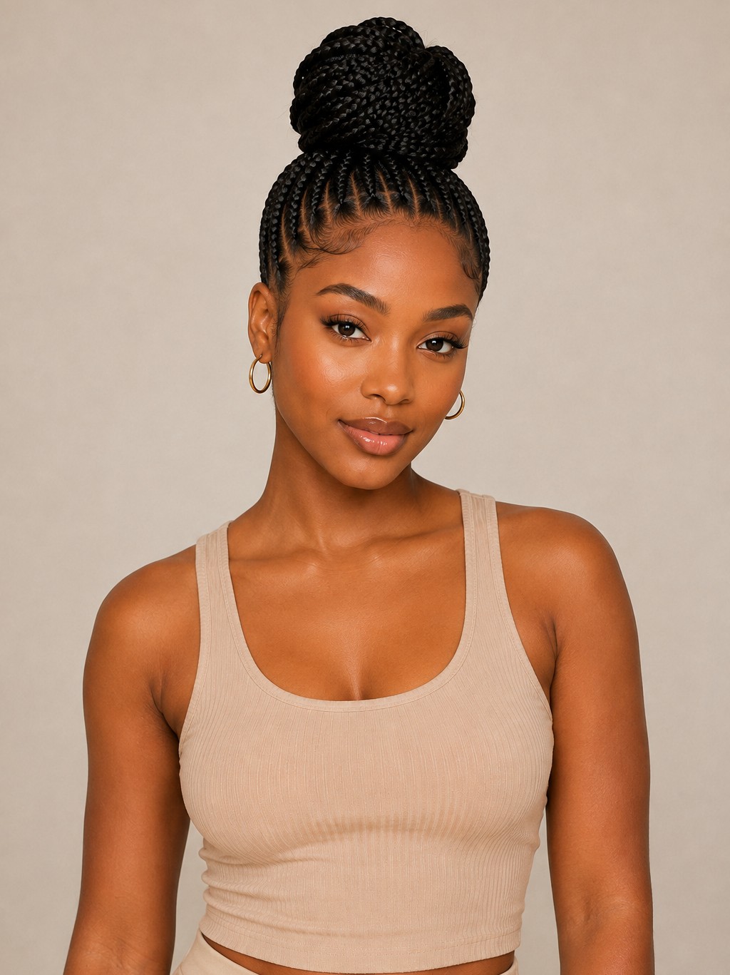 A high bun stacks all braids into a voluminous knot at the crown for an easy, secure style.